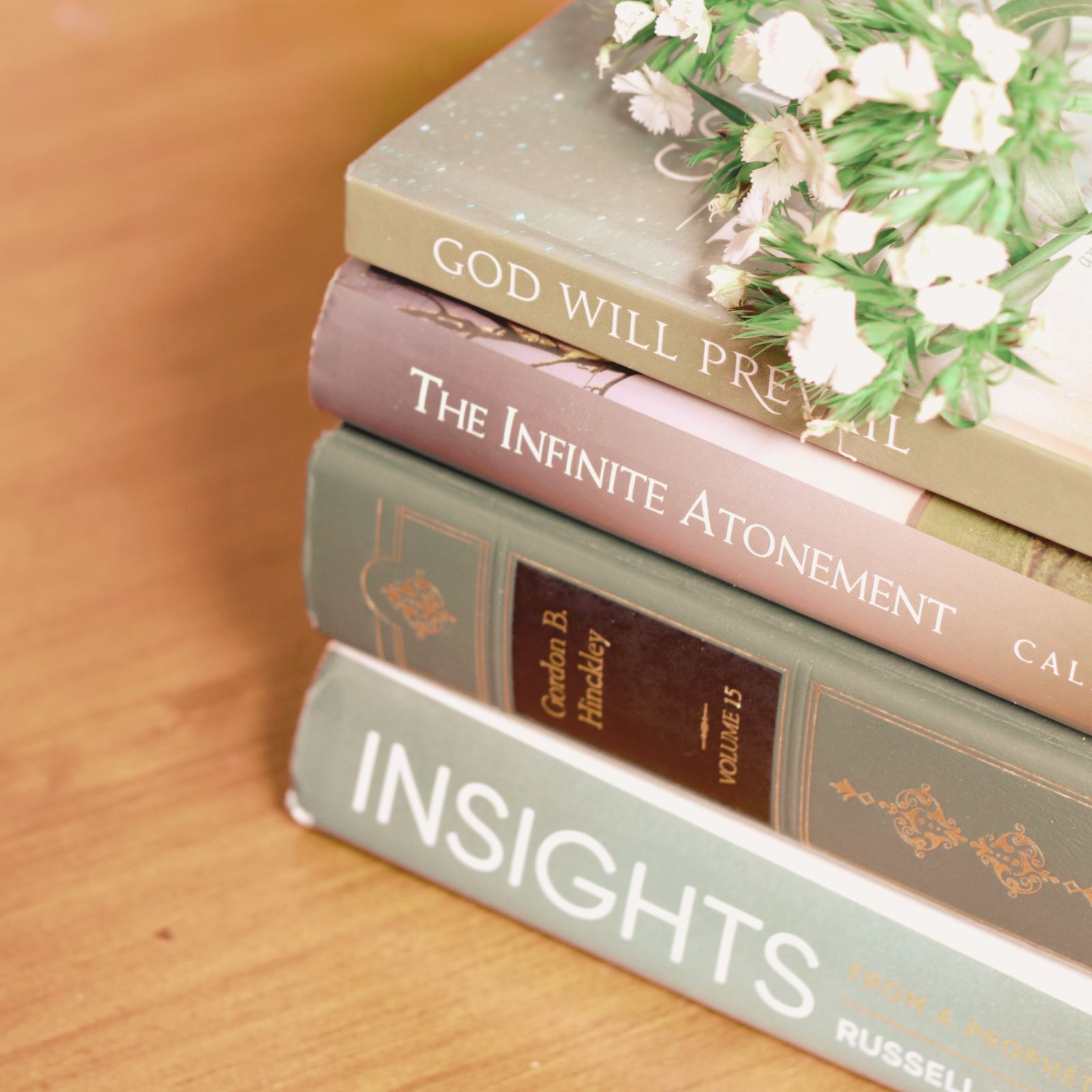 stack of books with flowers on top