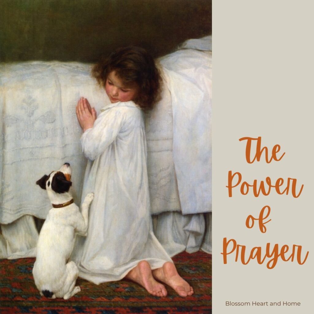 girl praying next to bed with dog